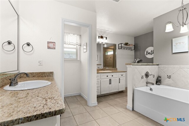 1037 Declaration Dr, Copperas Cove, TX 76522 - full bathroom with tile patterned floors, two vanities, and a bath