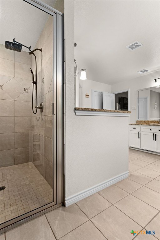 1037 Declaration Dr, Copperas Cove, TX 76522 - full bathroom featuring tile patterned flooring, a shower stall, vanity, and baseboards