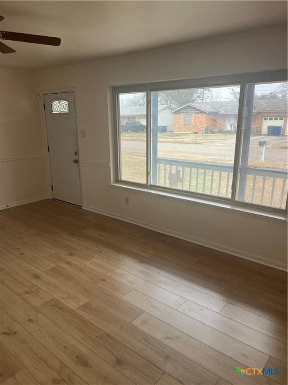 foyer entrance with ceiling fan and light hardwood / wood-style flooring