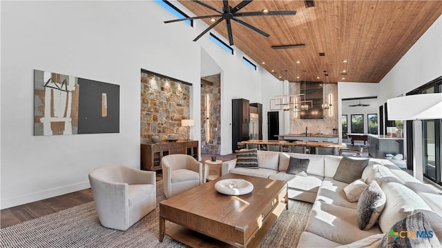 living room featuring wood ceiling, a towering ceiling, ceiling fan, and hardwood / wood-style floors