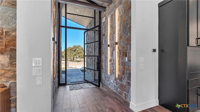 entrance foyer with beam ceiling and dark hardwood / wood-style floors