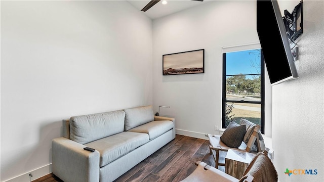 living area with ceiling fan and dark hardwood / wood-style floors