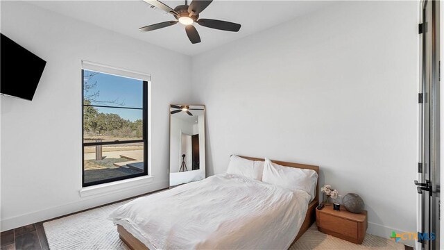 bedroom featuring hardwood / wood-style flooring and ceiling fan