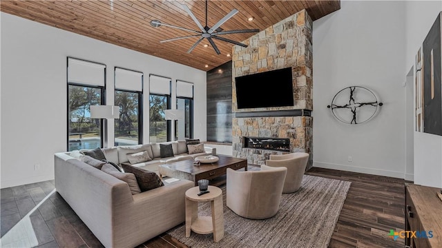 living room with a stone fireplace, high vaulted ceiling, wooden ceiling, dark hardwood / wood-style floors, and ceiling fan