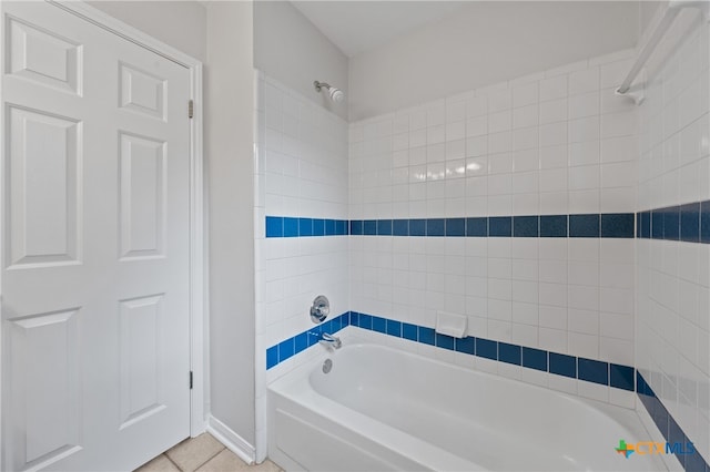 bathroom featuring tile patterned flooring and tiled shower / bath