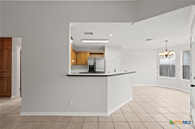 kitchen with decorative light fixtures, stainless steel fridge with ice dispenser, light tile patterned floors, and an inviting chandelier