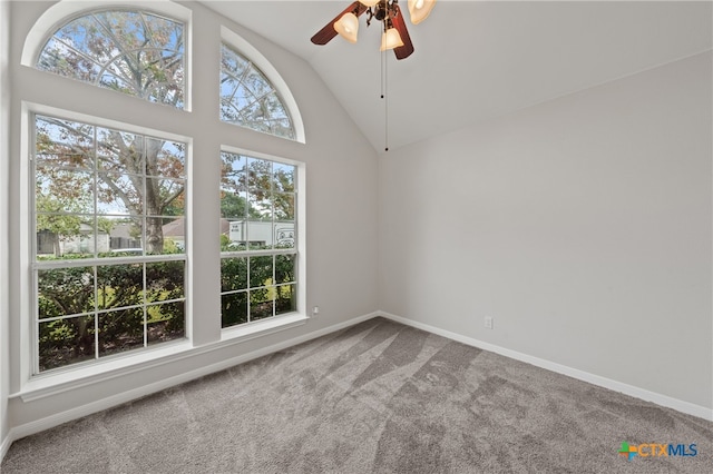 carpeted spare room featuring ceiling fan and high vaulted ceiling