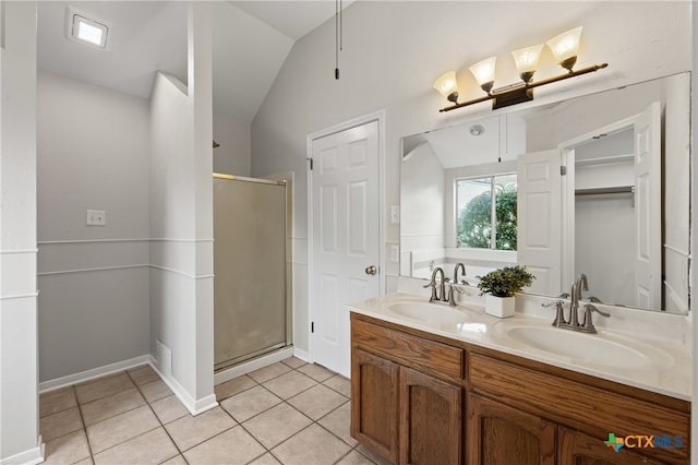 bathroom with tile patterned floors, vanity, an enclosed shower, and vaulted ceiling