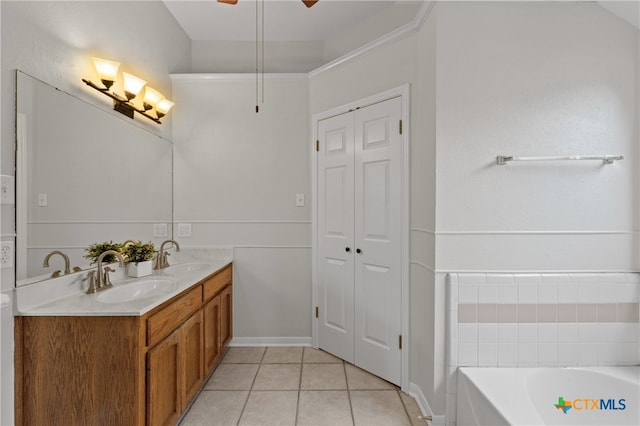 bathroom with tile patterned floors, vanity, ceiling fan, and a tub