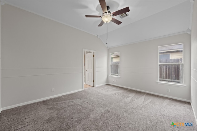 carpeted empty room featuring a wealth of natural light, lofted ceiling, and ceiling fan