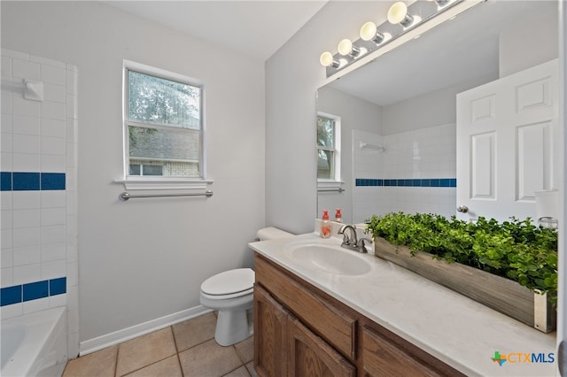 full bathroom featuring toilet, vanity, tile patterned floors, and a healthy amount of sunlight