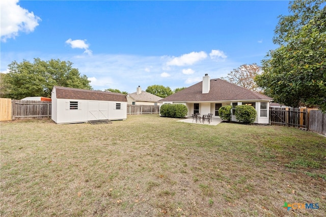 view of yard featuring a patio area and a storage shed