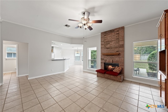 unfurnished living room featuring plenty of natural light, light tile patterned floors, and ornamental molding