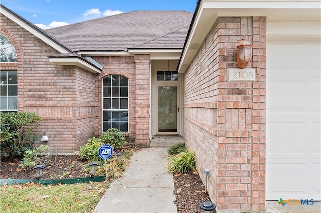 view of exterior entry with a garage