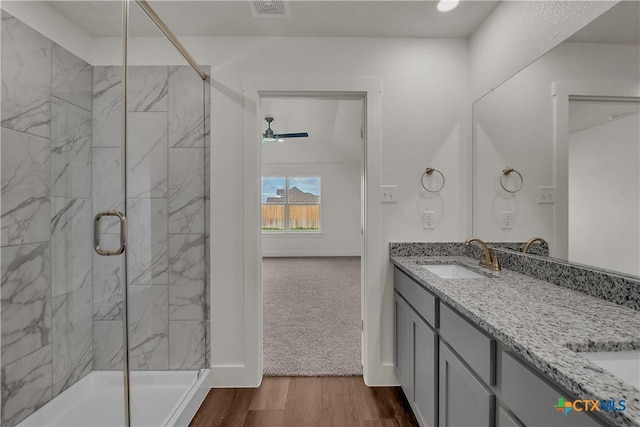 2302 Healy Dr, Temple, TX 76502 - full bath with double vanity, a stall shower, wood finished floors, and ceiling fan