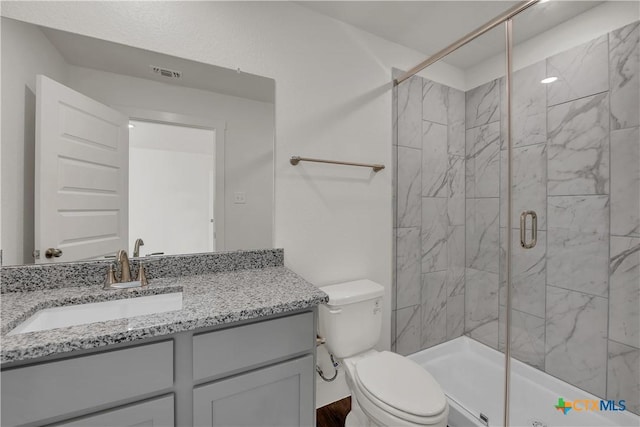 2302 Healy Dr, Temple, TX 76502 - bathroom with vanity, a shower stall, and wood finished floors