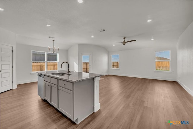 2302 Healy Dr, Temple, TX 76502 - kitchen featuring recessed lighting, a chandelier, wood finished floors, light stone counters, and a kitchen island with sink