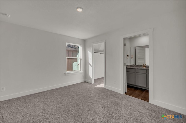 2302 Healy Dr, Temple, TX 76502 - unfurnished bedroom featuring dark carpet, a spacious closet, and ensuite bathroom