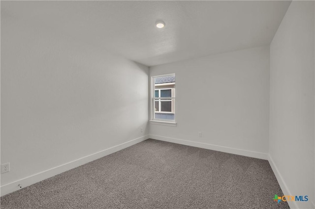 2302 Healy Dr, Temple, TX 76502 - spare room with dark colored carpet and baseboards