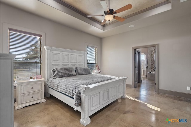 bedroom with ceiling fan, concrete flooring, ornamental molding, and a tray ceiling