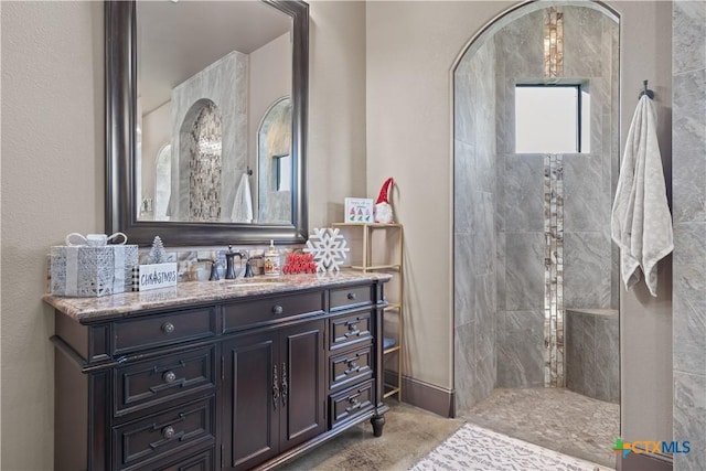 bathroom with a shower and vanity