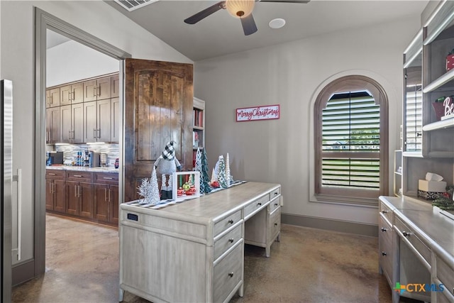 office area with ceiling fan, concrete flooring, and vaulted ceiling