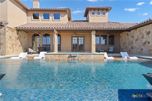 view of swimming pool with an in ground hot tub and ceiling fan