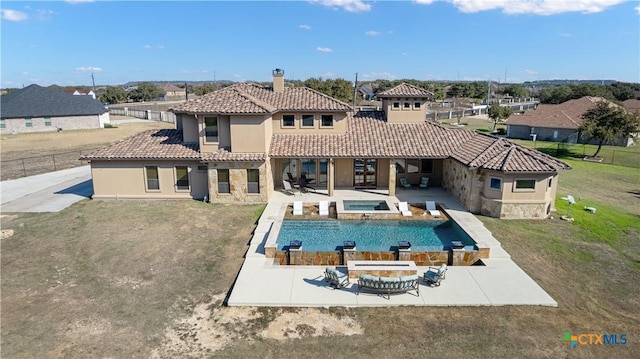 view of pool featuring a patio area, a yard, and an in ground hot tub