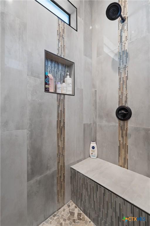 bathroom with tiled shower