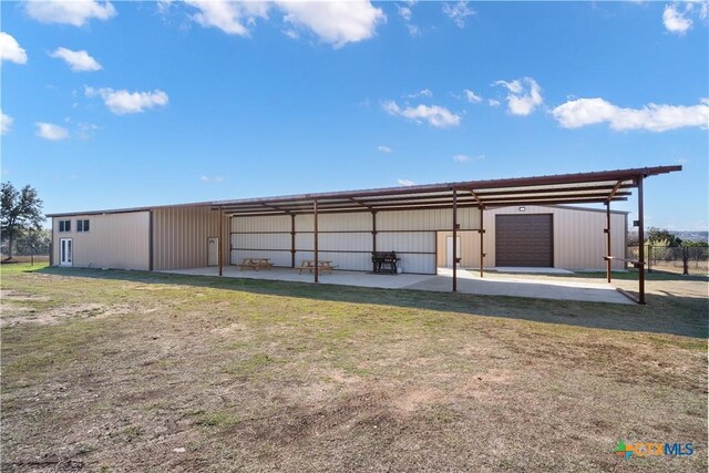 view of outbuilding featuring a lawn and a garage