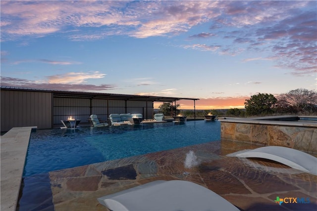 view of pool at dusk