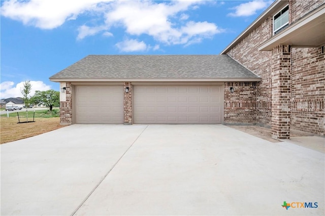 garage featuring concrete driveway