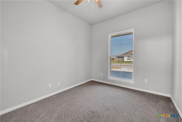 spare room featuring ceiling fan, baseboards, and carpet