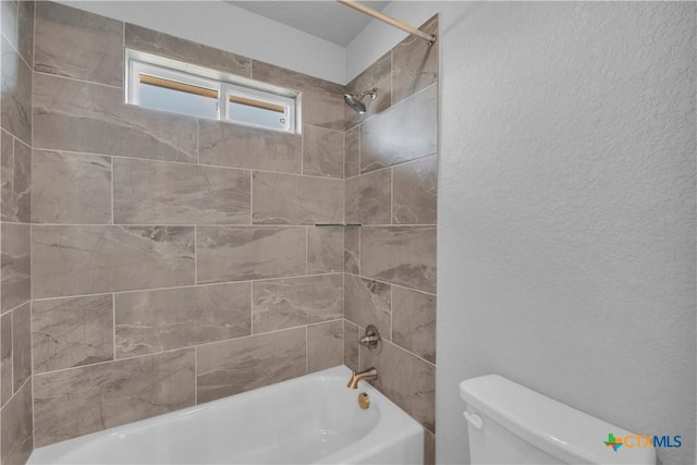 bathroom featuring bathtub / shower combination and toilet