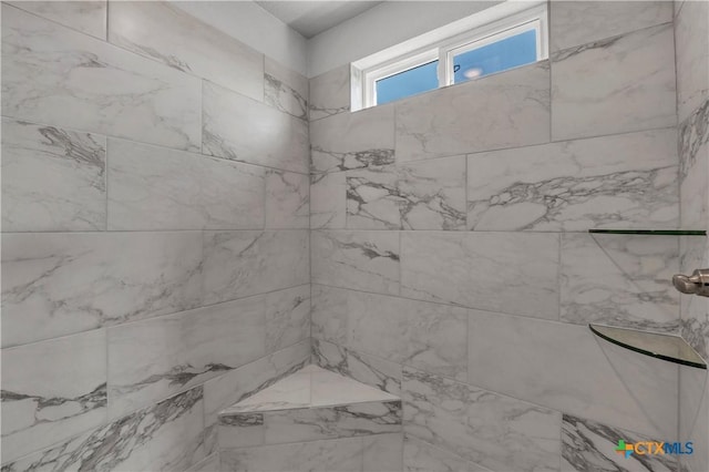 full bath featuring a tile shower