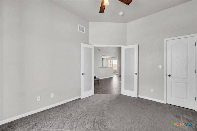 unfurnished bedroom with visible vents, carpet flooring, baseboards, and a ceiling fan
