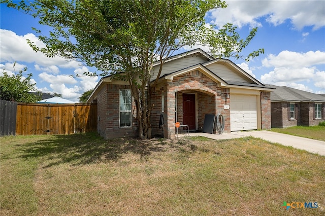 view of front of house with a garage and a front yard