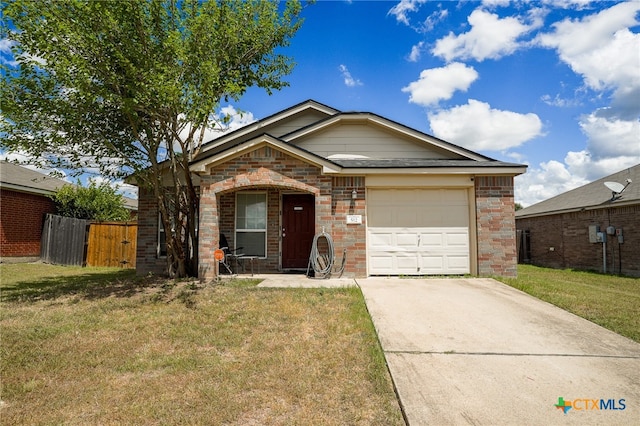 view of front of house featuring a garage and a front lawn