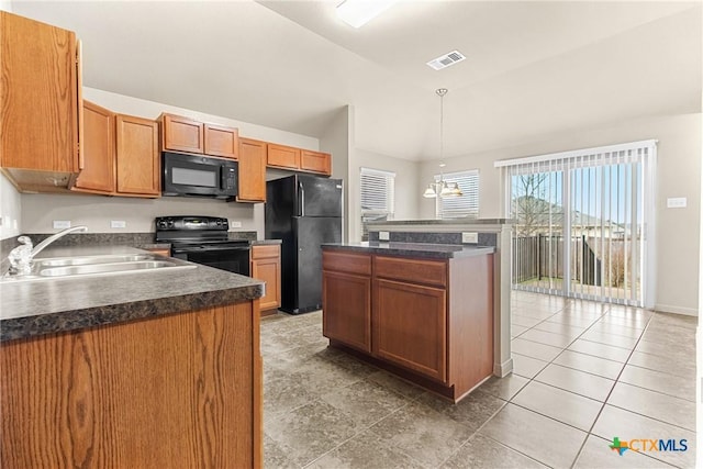 kitchen featuring decorative light fixtures, sink, a chandelier, a center island, and black appliances