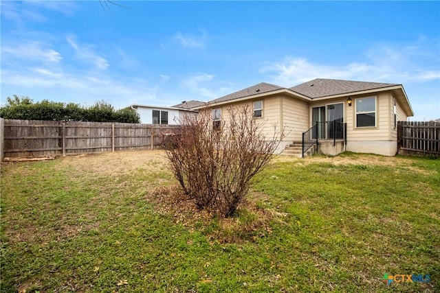 rear view of house with a lawn