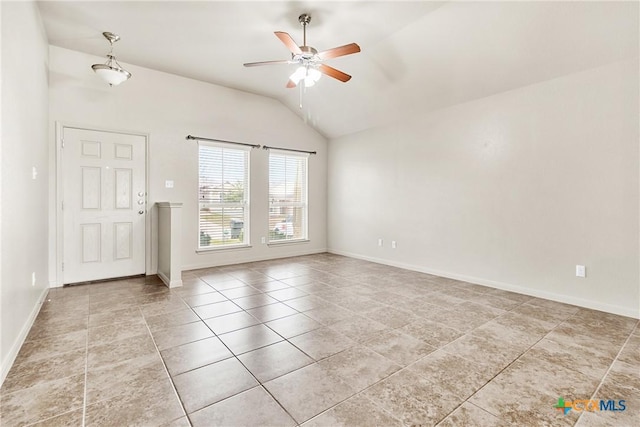 tiled empty room with vaulted ceiling and ceiling fan