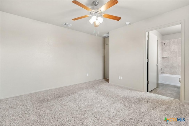 unfurnished bedroom with connected bathroom, light colored carpet, and ceiling fan