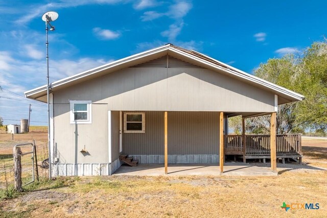 3300 State Highway 95, Shiner, TX 77984 - back of house with fence, entry steps, a carport, and a patio area