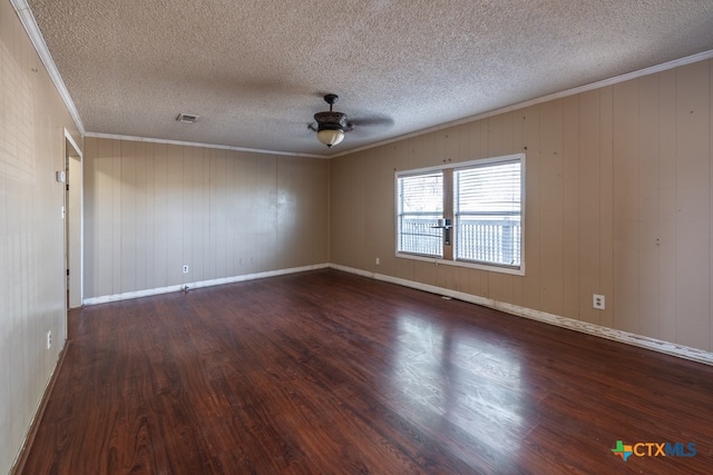 empty room with dark wood-type flooring, ceiling fan, and wooden walls