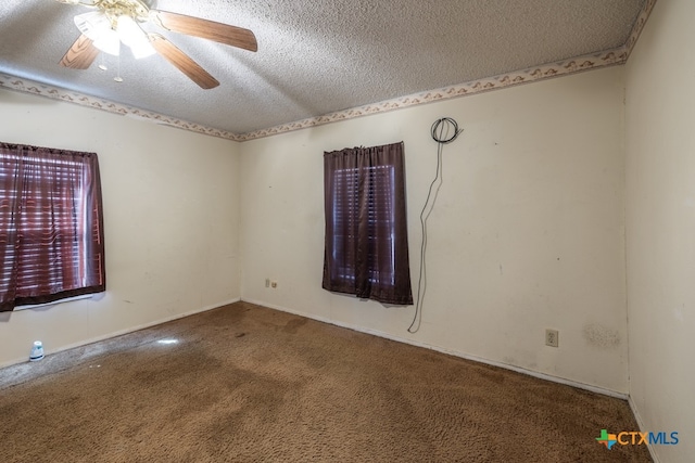 carpeted spare room with a textured ceiling and ceiling fan