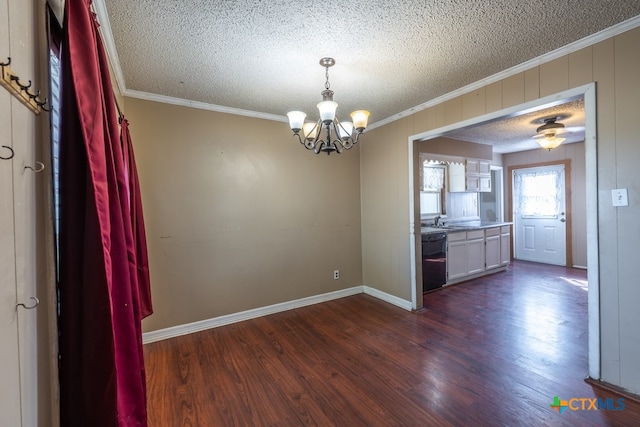 unfurnished dining area featuring dark wood-type flooring, sink, a textured ceiling, and crown molding