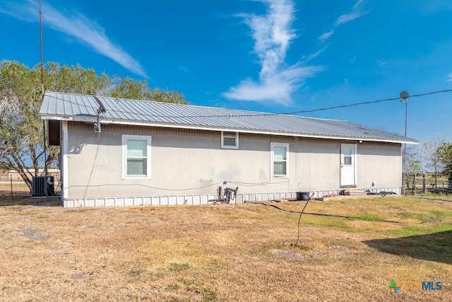 3300 State Highway 95, Shiner, TX 77984 - rear view of house featuring cooling unit, a yard, entry steps, and metal roof