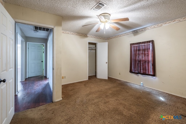 unfurnished bedroom with ceiling fan, a textured ceiling, a closet, and carpet