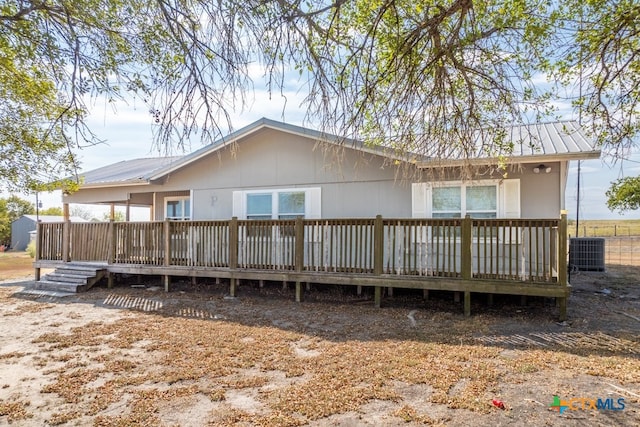 rear view of house featuring a deck and cooling unit