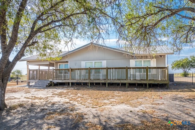 back of house with central AC unit and a wooden deck